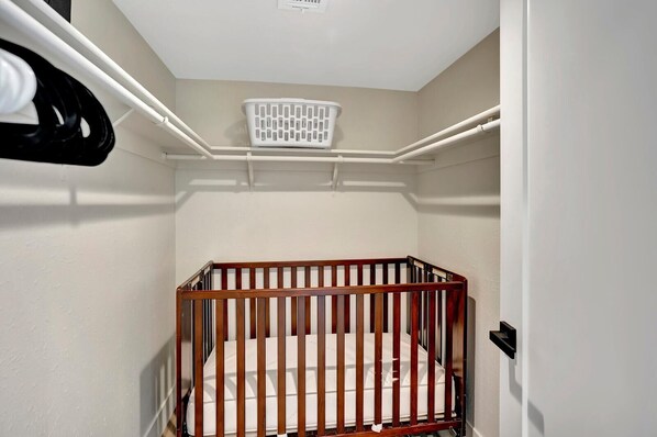 A small, enclosed room with a wooden crib, a white wall, and a white ceiling. - Slice Of Paradise, Remodel w/ FREE Heated Pool (Phoenix)