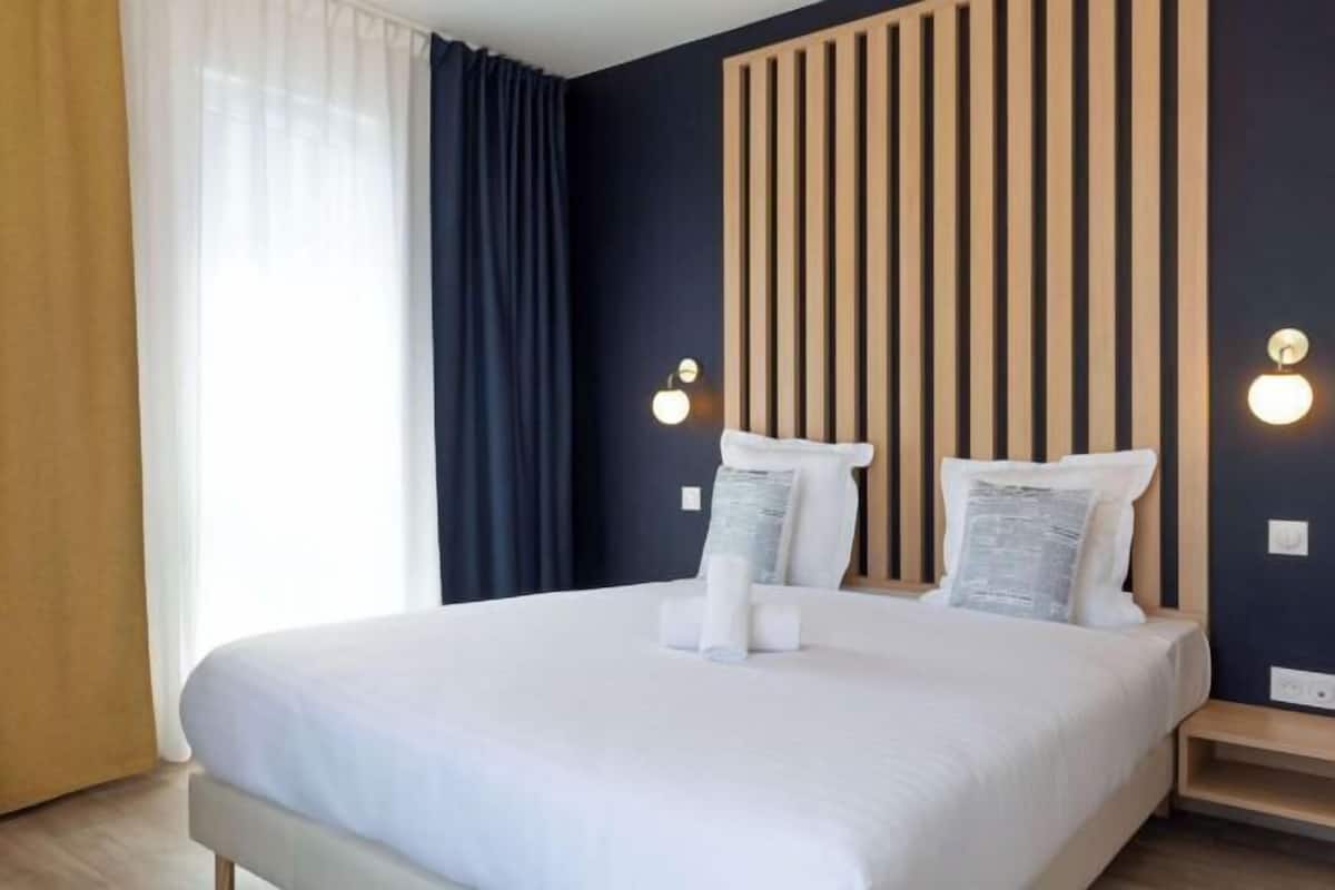 Premium bedding, desk, laptop workspace, blackout curtains