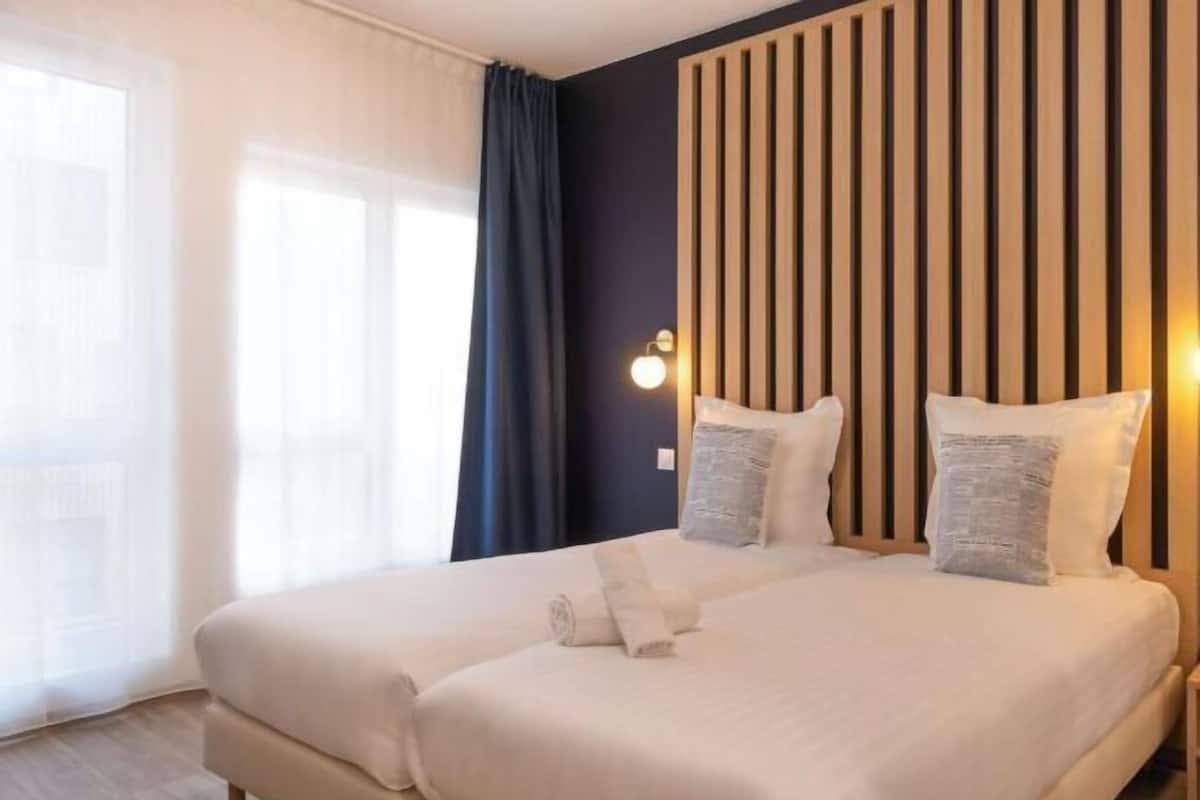 Premium bedding, desk, laptop workspace, blackout curtains