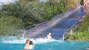 A swimming pool with a water slide. - Vacations with a view of the Argen, an oasis of peace in the Argen Valley (Neukirch)