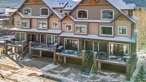A multi-story hotel with a ski slope in the background. - M3- Serene Canmore Retreat- A/C, Free EV Charge, 5BD, 4.5BT, Hot Tub, Mtn View (Canmore)