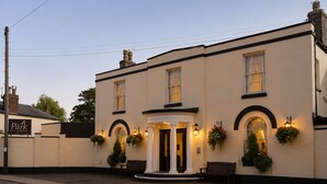 A two-story building with a prominent entrance, columns, and hanging flower baskets. - The Park Hotel, Sure Hotel Collection by Best Western (Diss)
