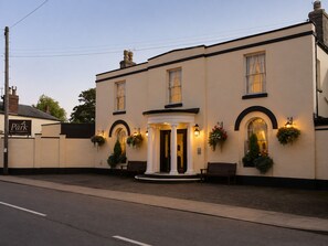 A two-story building with a prominent entrance, columns, and hanging flower baskets. - The Park Hotel, Sure Hotel Collection by Best Western (Diss)