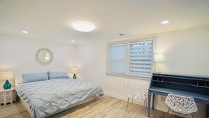 A bedroom with a bed, a piano, and a window with blinds. - Santorini Cave Style Cottage with Fenced-in Yard (Chapel Hill)
