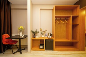 Enjoy a compact room with a dining area, wardrobe, refrigerator, and cabinet.