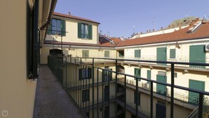 A multi-story building with balconies, a staircase, and a view of neighboring buildings. - Italianway Easy - Bligny 64 (Milan)