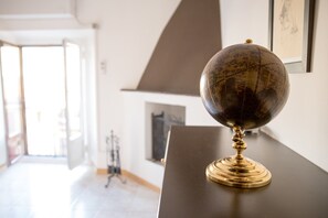 Un globo sobre una superficie oscura en una habitación con una pared blanca y un cuadro enmarcado.