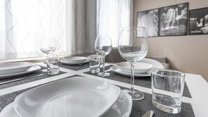 A neatly set dining table with plates, glasses, and cutlery, suggesting a formal dining experience. - Italianway Easy - Cadorna 10 Mono A (Milan)