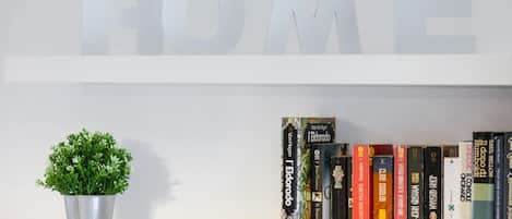 A bookshelf with books and a potted plant.