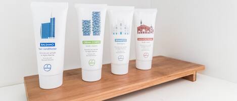 Four hair care products on a wooden shelf.