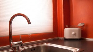 A kitchen with a stainless steel sink, a modern faucet, and a white toaster on the counter. - Italianway Easy - Corso Lodi 78 (Milan)