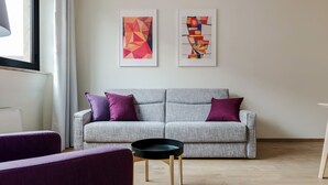 A modern living room with a grey sofa, purple cushions, and two abstract paintings on the wall. - Mi-brgz1c3 Bergonzoli Place - Bilo B - Hugo (Milan)