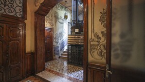 A grand hallway with ornate wood paneling, a tiled floor, and a staircase leading to an upper level. - Italianway Comfort - Lombardia 96 (Milan)