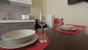 A dining table with white plates, a wine glass, and a small glass. - Italianway Easy - Melzo 12 - Vintage (Milan)