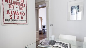 A room with a glass table, a book, and a poster on the wall. - Borsieri 22 (Milan)