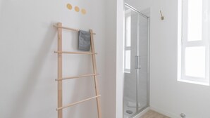 A room with a wooden ladder, a glass shower door, and a window with a view. - Italianway Comfort - Buenos Aires 65 A (Milan)