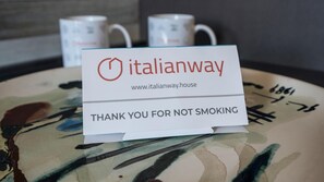 Een bord op een tafel met de tekst 'italianway' en 'BEDANKT VOOR HET NIET ROKEN'.