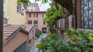 Stroll through a charming alleyway lined with traditional buildings and lush greenery.