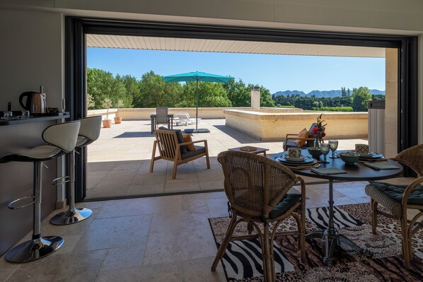 A modern dining area with a view of a mountainous landscape.
