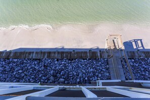 A wooden pier leading to a beach with a rocky shoreline. - Beachfront, Bayview, Relax ~ Edgewater Retreat (Cape San Blas)
