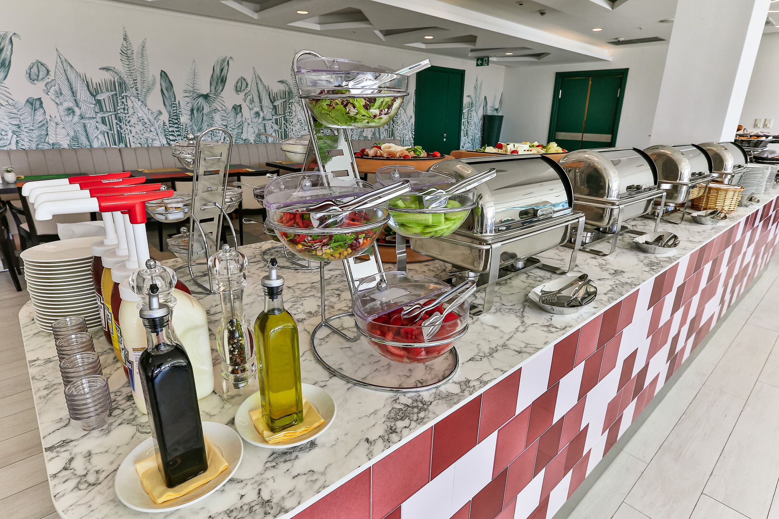 A buffet setup with various food items and condiments.
