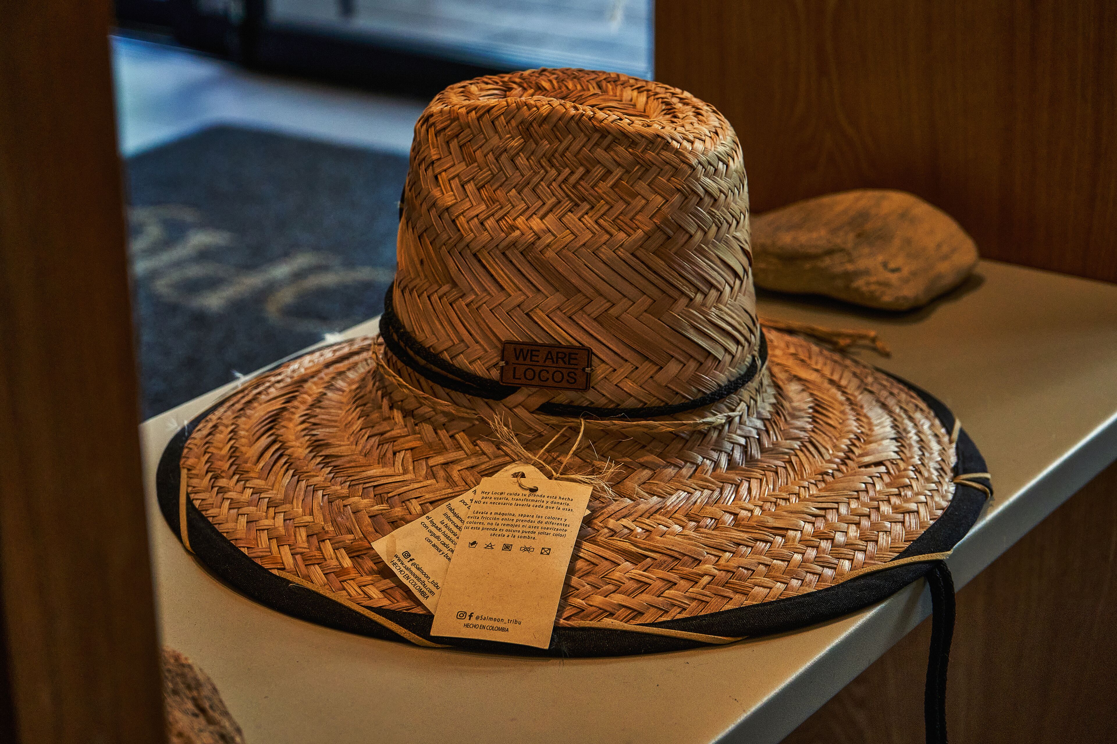 A woven hat with a tag on a display counter.