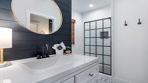 Bathtub, hair dryer, towels, shampoo