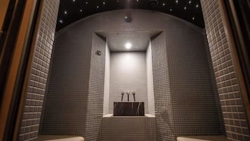 Enjoy a refreshing shower in this bathroom with a central sink area and bench.