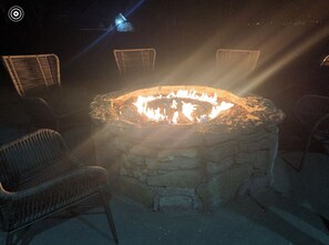 Sit by the fire and enjoy the warmth in this outdoor seating area.