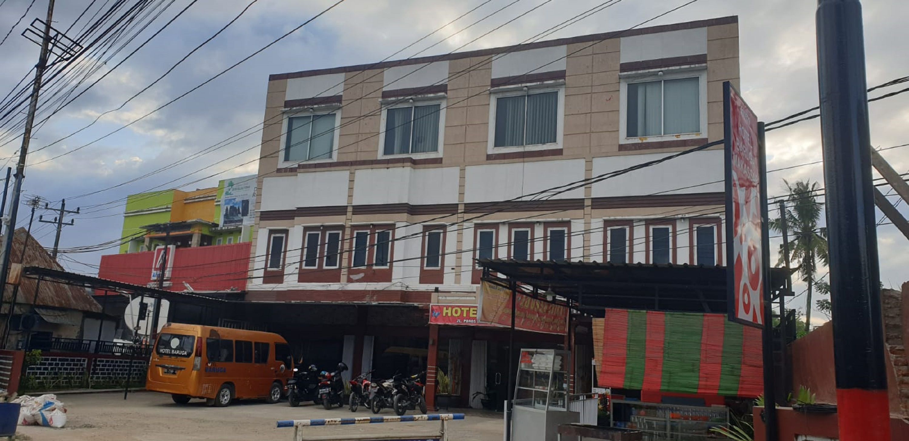 A multi-story building with a ground-level commercial space and a hotel on the upper floor.