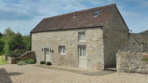 A stone building with a pitched roof, two windows, and a door. - The Barn, Park Farm near Chew Magna, Bristol (Bristol)