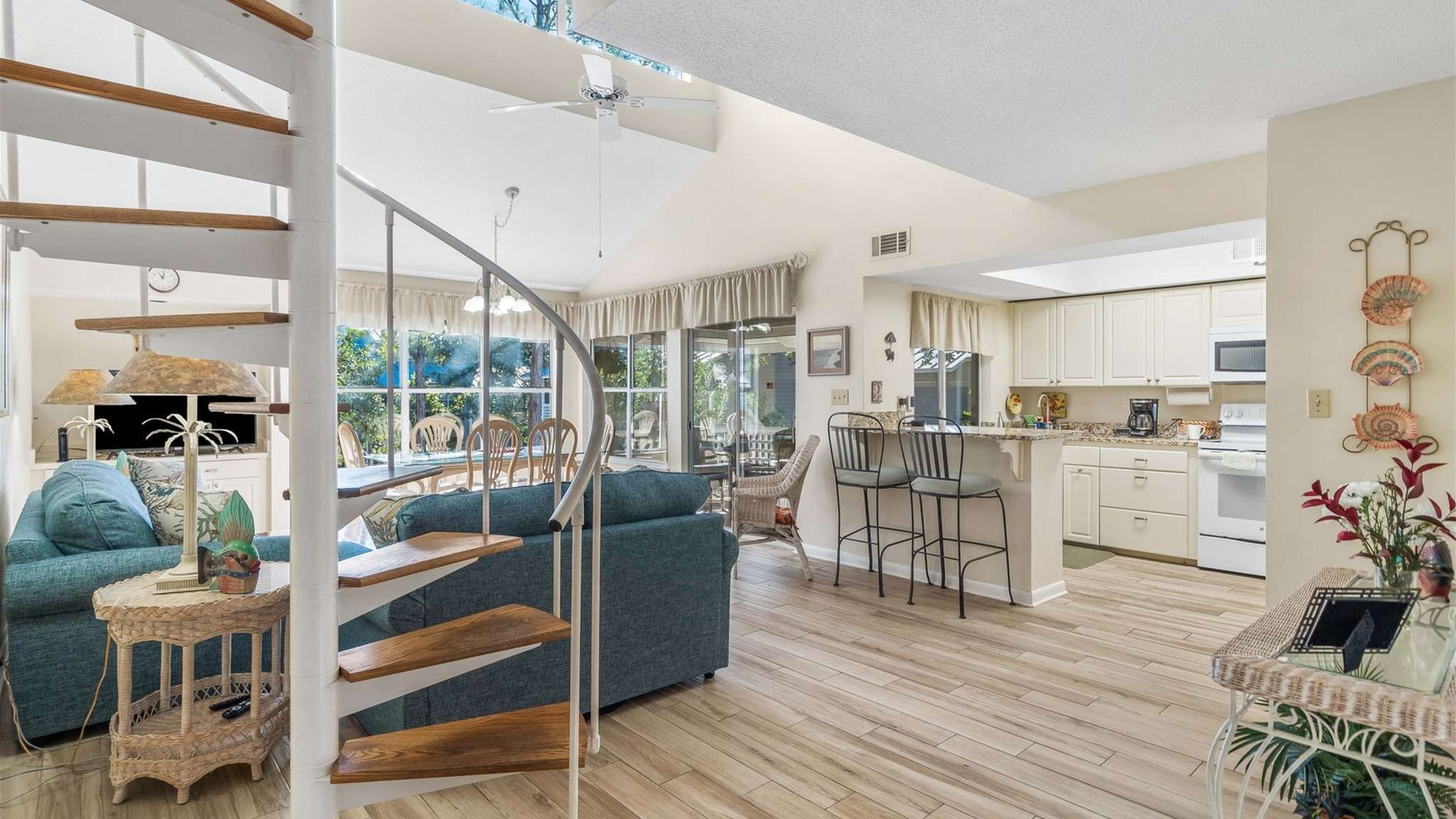 A modern interior with a staircase, a dining area, and a kitchen.