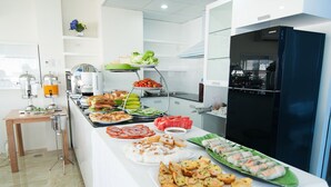 A buffet with various dishes including sandwiches, salads, and desserts. - Me Gustas Downtown Hotel (Ho Chi Minh City)