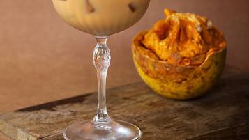 A dessert in a glass on a wooden board.