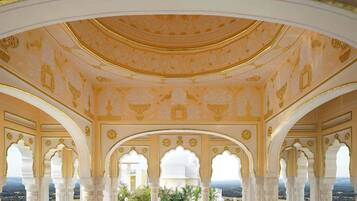 Interior ornamentado com arcos e teto estampado.