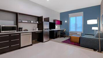 A modern kitchen with a built-in microwave, refrigerator, and dishwasher.