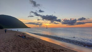 A beach with a clear sky and a sunset.
