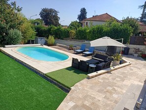 A backyard with a swimming pool, a patio area with outdoor furniture, and a well-maintained lawn. - 🦋 Liittle Cocoon  -  Private Parking - Near Tram & Métro (Venissieux)