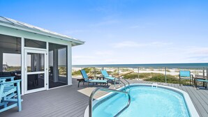 A pool area with a view of the beach, deck chairs, and a covered seating area. - Luxury Gulf-Front Retreat. Heated Pool, Pet-Friendly.  (Cape San Blas)