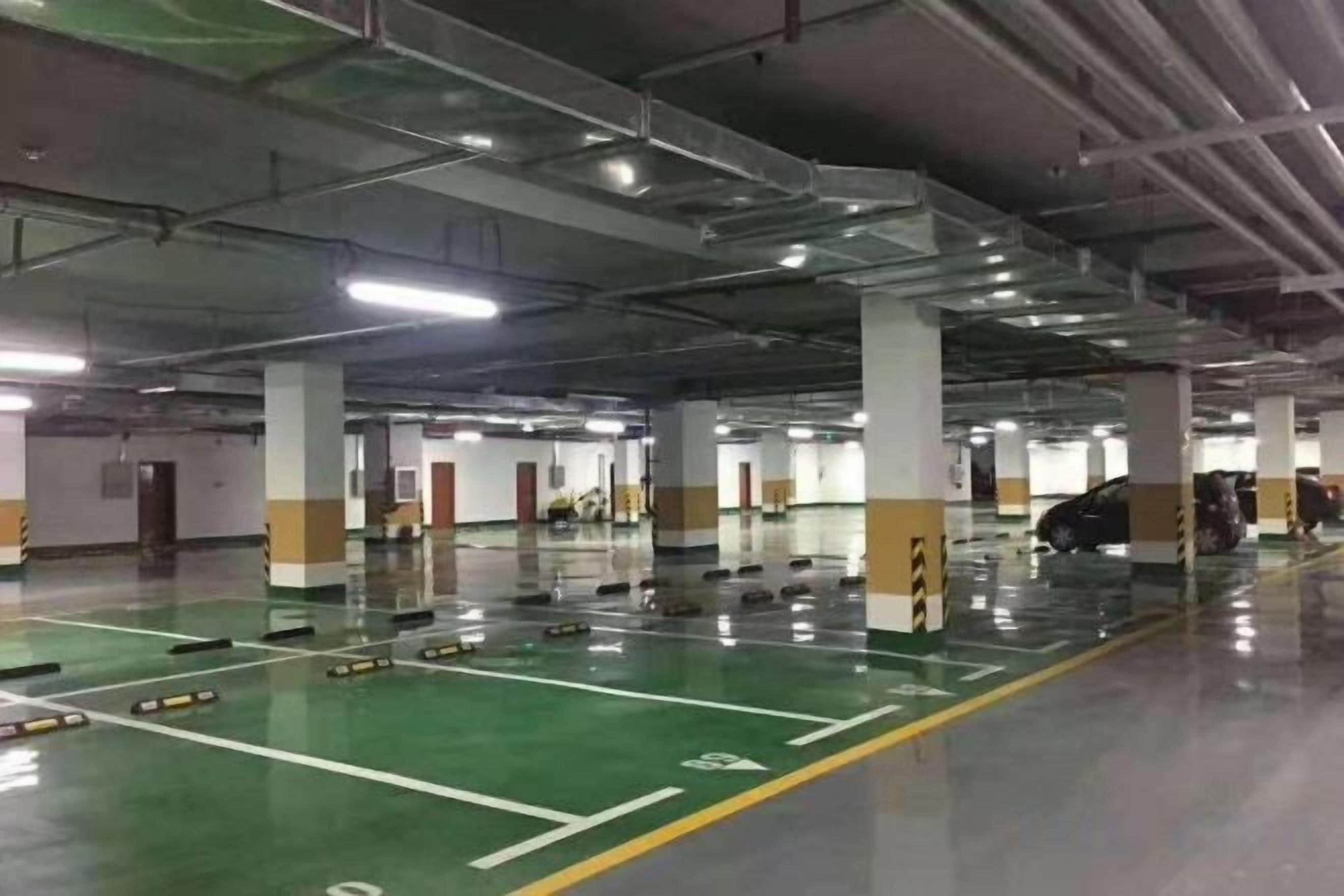 A multi-level parking garage with clear signage, multiple parking spaces, and a clean, well-lit environment.
