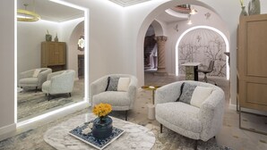 A modern living room with a marble coffee table, two grey armchairs, and a large mirror. - Casa Cleo Boutique Stays by Viadora (Mexico City)