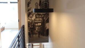 A corridor with a black and white photo of a street scene, including a sign for 'WILU Joe's Coffee Shop'. - Modern Lux Cottage, Mtn Views, Close to Downtown (Bozeman)