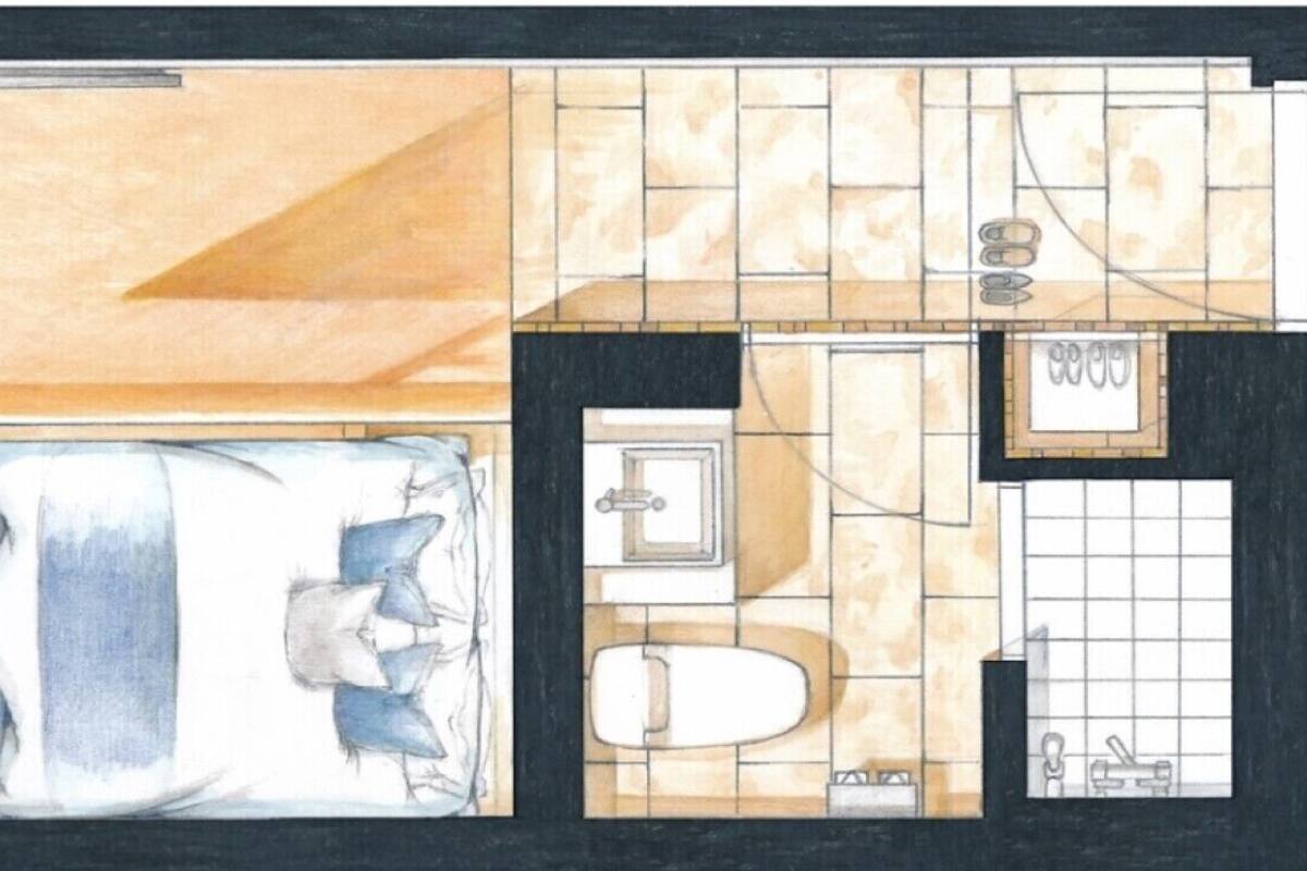Plano de una habitación de hotel con cama, dos mesitas de noche, un pequeño rincón de descanso y un baño con inodoro, lavamanos y ducha.