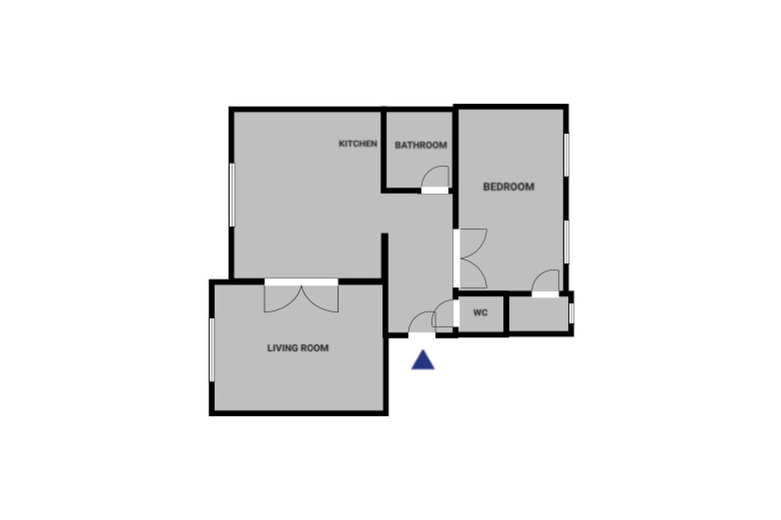 A floor plan with a kitchen, bathroom, bedroom, living room, and WC.