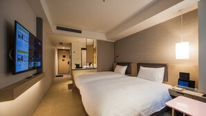 A hotel room with a large bed, a bedside table with a lamp, a TV mounted on the wall, and a mirror above the bed. - Montblanc Hotel RAFFINE NAGOYA EKIMAE (Nagoya)