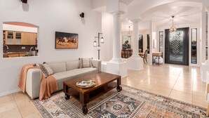 A spacious living room with a sofa, coffee table, and patterned rug. - ★ Jump in! ★ Luxurious spread in the desert & no annoying neighbors! Comfy beds! (Fountain Hills)