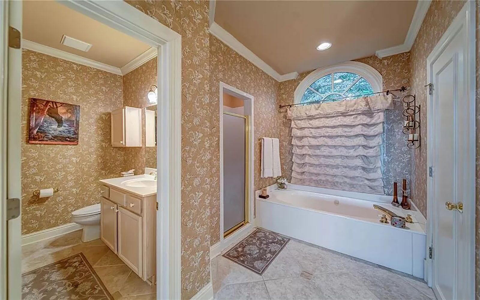 A bathroom with a bathtub, a sink, and a toilet.
