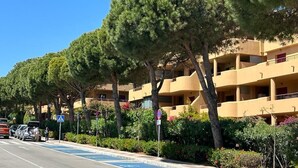 A row of multi-story buildings with balconies, surrounded by trees and greenery. - La Cala 2 Bedroom Apt with Sea View and Pool View (La Cala de Mijas)