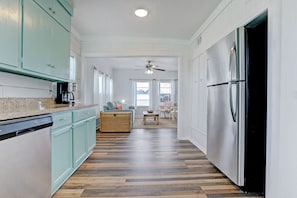 Enjoy cooking in this well-equipped kitchen with a central island, stainless steel appliances, and ample cabinetry.