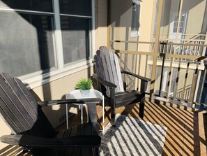Sit and enjoy the view from this outdoor seating area with Adirondack chairs and a small table.
